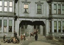 Children with adult in the tenement district, Brockton, Massachusetts, 1940. Creator: Jack Delano