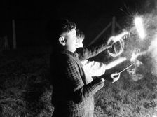 Children with fireworks, c1955. Creator: Arthur Charles Kirby Ware