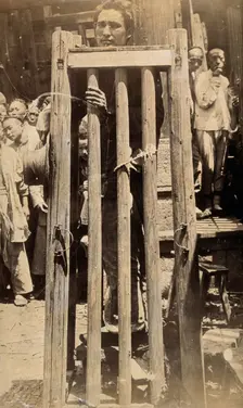 China: a man standing in a locked cage as a method of slow torture or execution, 19th century. Creator: Unknown