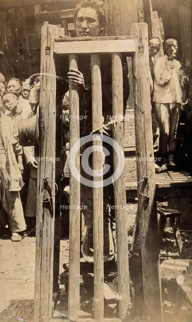 China: a man standing in a locked cage as a method of slow torture or execution, 19th century. Creator: Unknown.