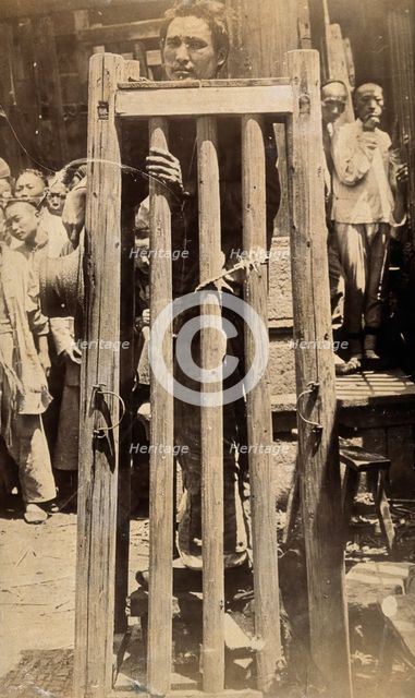 China: a man standing in a locked cage as a method of slow torture or execution, 19th century. Creator: Unknown.
