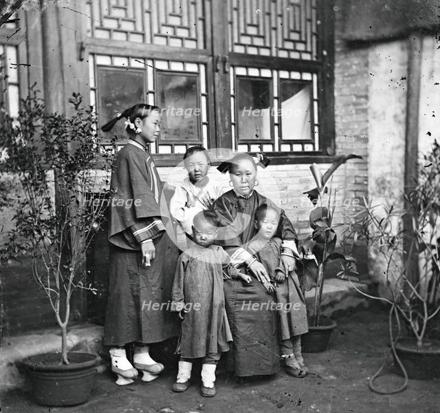 China: a Manchu lady with her daughter in-law and grandchildren, Beijing, 1869. Creator: John Thomson.