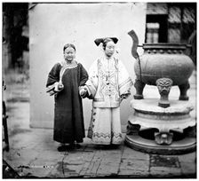 China: a Manchu woman with her maid standing beside a bronze burner, Beijing, 1869. Creator: John Thomson