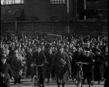 Chinese Refugees Including Several With Bicycles Spilling Through Barriers..., 1937. Creator: British Pathe Ltd