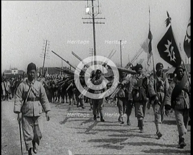 Chinese Soldiers Marching Carrying Flags and Other Equipment, 1920s. Creator: British Pathe Ltd.