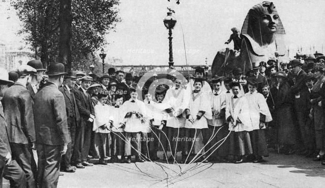 Choirboys of St Clement Danes beating the boundary-marks with long wands, London, 1926-1927. Artist: Unknown