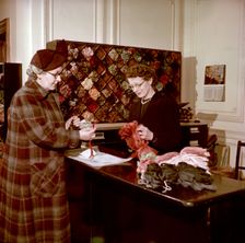 Choosing wools at the shop counter, Royal School of Needlework, c1955. Creator: Arthur Charles Kirby Ware