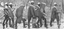 'Choses vues a la guerre; territoriaux revenant de corvee sous la pluie. 1915. Creator: Georges Leroux