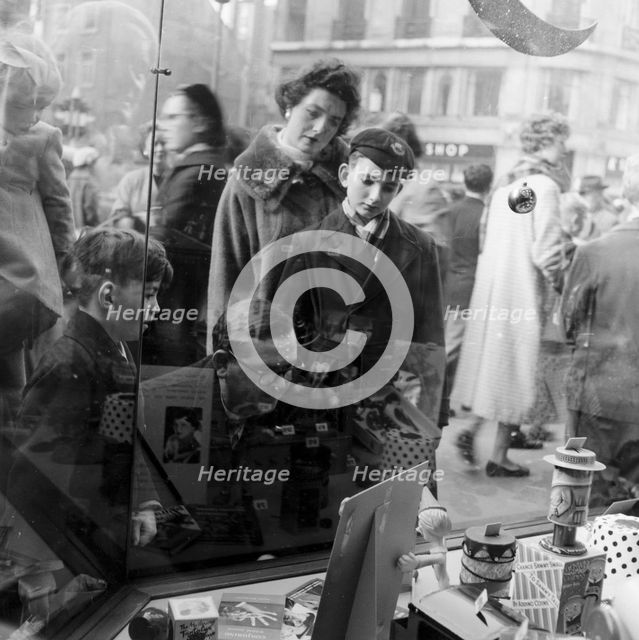 Christmas shoppers outside a toyshop, London, 1957. Creator: Henry Grant.