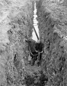 Civil engineers in a trench with a pneumatic drill, Oldcoats, Nottinghamshire, 1961. Creator: Michael Walters