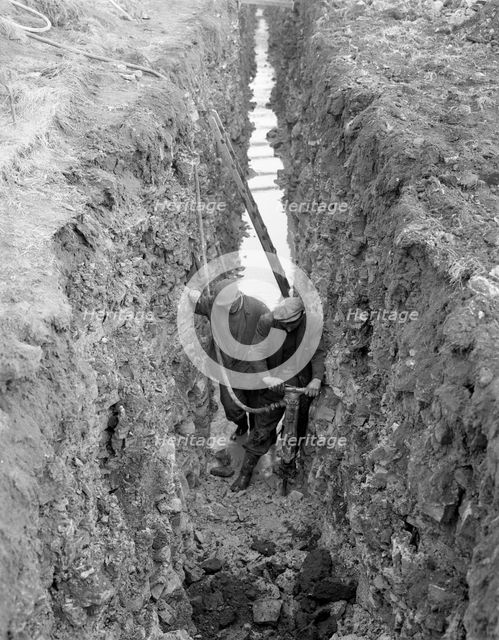 Civil engineers in a trench with a pneumatic drill, Oldcoats, Nottinghamshire, 1961. Creator: Michael Walters.