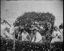 Civilians on a Boat Heavily Decorated with Flowers, 1920. Creator: British Pathe Ltd