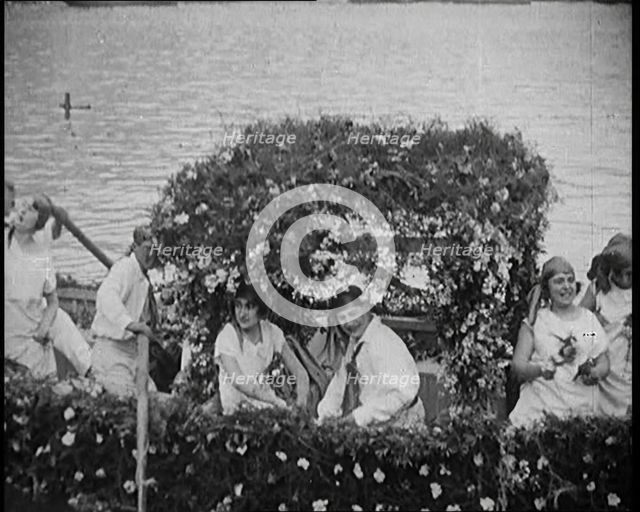Civilians on a Boat Heavily Decorated with Flowers, 1920. Creator: British Pathe Ltd.