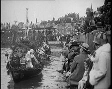 Civilians on the Margin of a River Throwing Flowers to Civilians on a Boat Heavily Decorated...1920 Creator: British Pathe Ltd