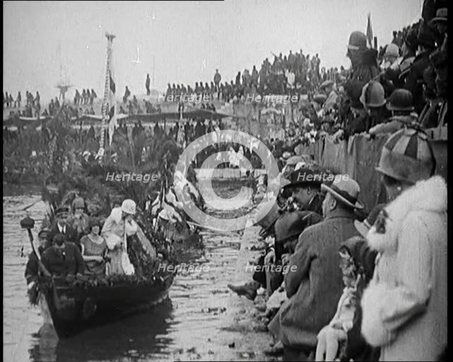 Civilians on the Margin of a River Throwing Flowers to  Civilians on a Boat Heavily Decorated...1920 Creator: British Pathe Ltd.