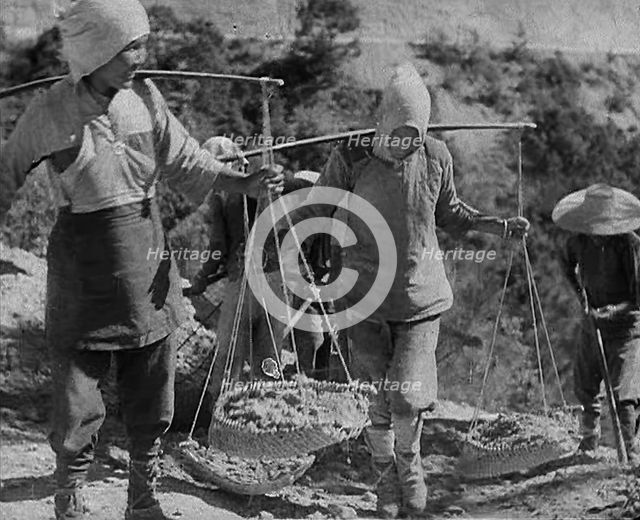 Civilians Carrying Supplies Along the Ledo or  Burma Road, 1943. Creator: British Pathe Ltd.