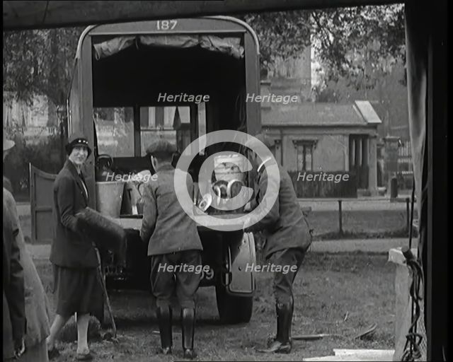 Civilians Dismantling an Emergency Food Distribution Centre and Loading Products Into a..., 1926. Creator: British Pathe Ltd.