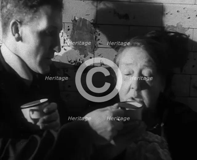 Civilians Drinking Hot Drinks While Sheltering from Bombs in the London Underground, 1940. Creator: British Pathe Ltd.