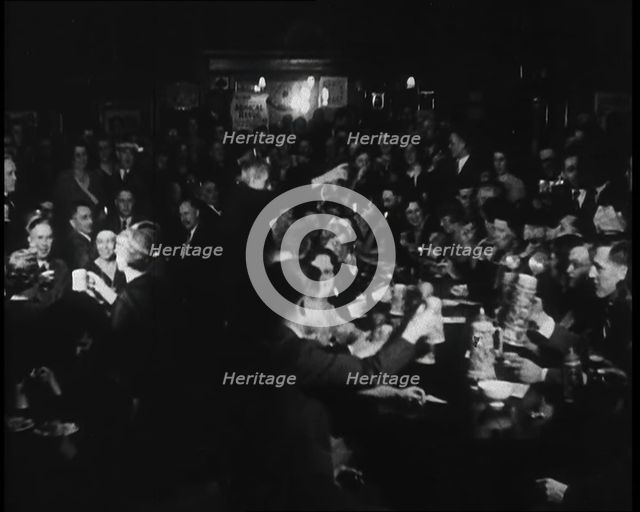 Civilians Drinking in a Bar in Celebration, 1930s. Creator: British Pathe Ltd.