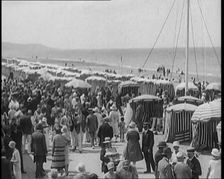 Civilians Enjoying a Sunny day on a Very Crowded Beach, 1920. Creator: British Pathe Ltd