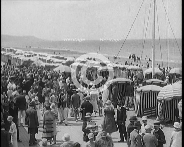 Civilians Enjoying a Sunny day on a Very Crowded Beach, 1920. Creator: British Pathe Ltd.