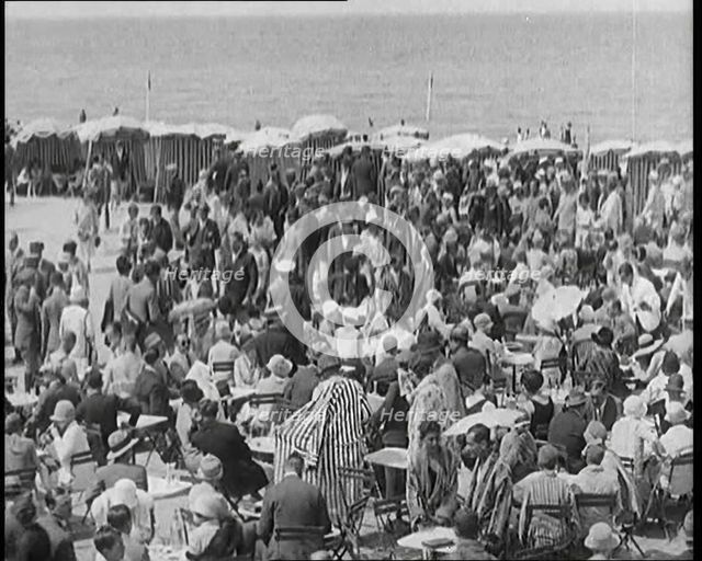 Civilians Enjoying a Sunny day on a Very Crowded Beach, 1920. Creator: British Pathe Ltd.