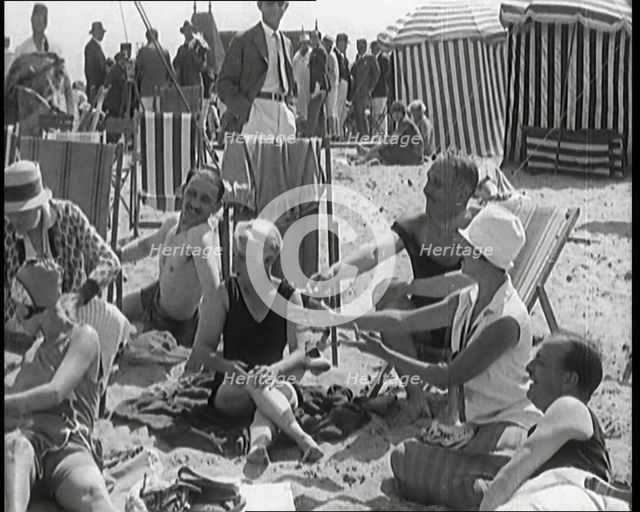Civilians Enjoying a Sunny day on a Very Crowded Beach, 1920. Creator: British Pathe Ltd.