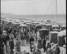 Civilians Enjoying a Sunny day on a Very Crowded Beach, 1920. Creator: British Pathe Ltd