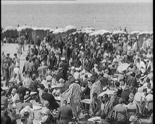 Civilians Enjoying a Sunny day on a Very Crowded Beach, 1920. Creator: British Pathe Ltd