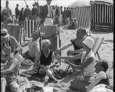 Civilians Enjoying a Sunny day on a Very Crowded Beach, 1920. Creator: British Pathe Ltd