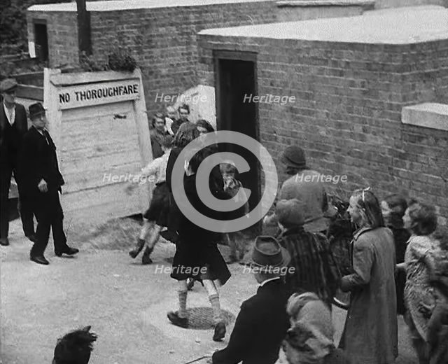 Civilians Entering an Air Raid Shelter to Escape German Shelling, 1940. Creator: British Pathe Ltd.