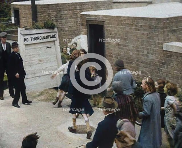 Civilians Entering an Air Raid Shelter to Escape German Shelling, 1940. Creator: British Pathe Ltd.