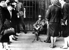 Civilians in front of a German guard post with a machine gun, Paris, June 1940