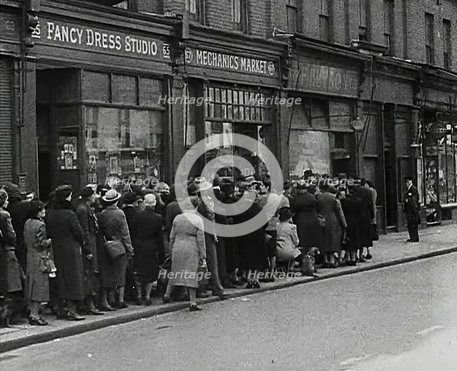 Civilians Queueing Outside a Food Shop, 1942. Creator: British Pathe Ltd.