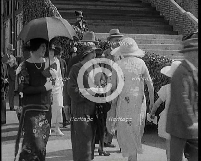 Civilians Walking Outdoors Wearing Evening Outfits and Hats, 1920. Creator: British Pathe Ltd.