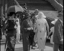 Civilians Walking Outdoors Wearing Evening Outfits and Hats, 1920. Creator: British Pathe Ltd
