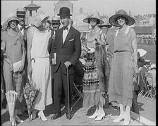 Civilians Wearing Smart Outfits and Hats Posing for the Camera During a Horse Race, 1920. Creator: British Pathe Ltd