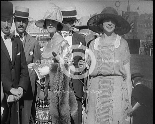 Civilians Wearing Smart Outfits and Hats Posing for the Camera During a Horse Race, 1920. Creator: British Pathe Ltd.