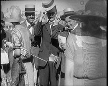 Civilians Wearing Smart Outfits and Hats Posing for the Camera During a Horse Race, 1920. Creator: British Pathe Ltd