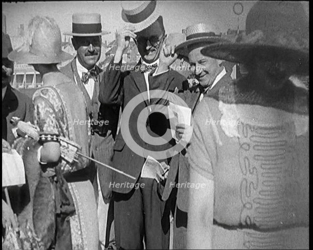 Civilians Wearing Smart Outfits and Hats Posing for the Camera During a Horse Race, 1920. Creator: British Pathe Ltd.