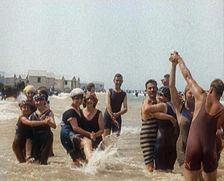Civilians Wearing Swimsuits Enjoying a Sunny Day Dancing at a Very Crowded Beach, 1920. Creator: British Pathe Ltd