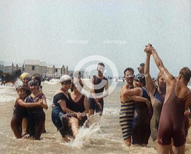 Civilians Wearing Swimsuits Enjoying a Sunny Day Dancing at a Very Crowded Beach, 1920. Creator: British Pathe Ltd.