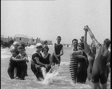Civilians Wearing Swimsuits Enjoying a Sunny Day Dancing at a Very Crowded Beach, 1920. Creator: British Pathe Ltd
