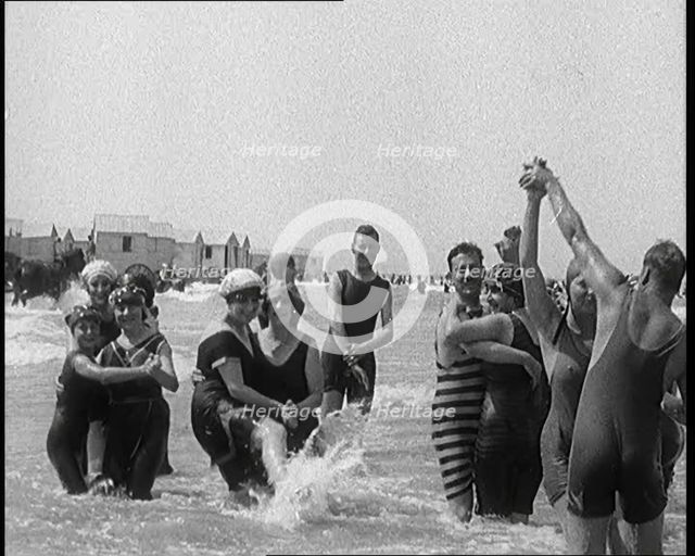 Civilians Wearing Swimsuits Enjoying a Sunny Day Dancing at a Very Crowded Beach, 1920. Creator: British Pathe Ltd.