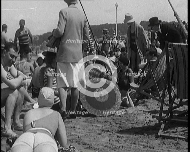 Civilians Wearing Swimsuits Leasuring on a Beach, 1920. Creator: British Pathe Ltd.