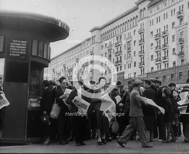 Civilians with newspapers in the Streets of Moscow, 1941.  Creator: British Pathe Ltd.