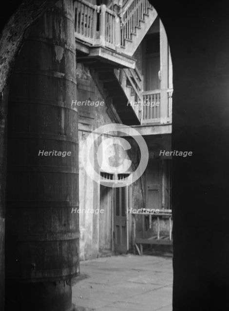 Cistern and outer stairs of an old-time courtyard, New Orleans, between 1920 and 1926. Creator: Arnold Genthe.
