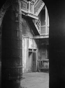 Cistern and outer stairs of an old-time courtyard, New Orleans, between 1920 and 1926. Creator: Arnold Genthe