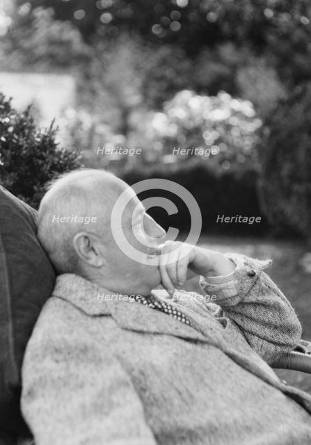 Clucas, E.W., seated outdoors, 1931 June 14. Creator: Arnold Genthe.
