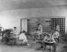 Classroom scenes at Carlisle, Pa., Indian School. Shoe making and repairing; male students, 1901. Creator: Frances Benjamin Johnston